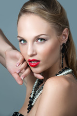 Young woman model with glamour red lips,bright makeup, eye arrow