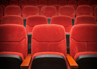 Fototapeta premium Red velvet armchairs in the empty auditorium