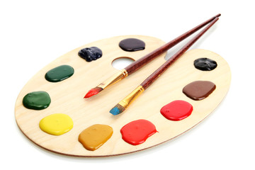 wooden art palette with  paint and brushes.isolated on white