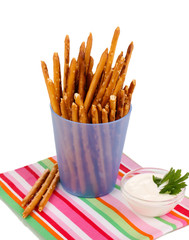 Tasty crispy sticks in purple plastic cup isolated on white