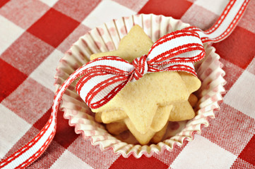 Star cookies with ribbon on  checkered cloth