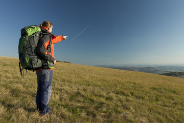 Young female  tourist pointing hand to the castle
