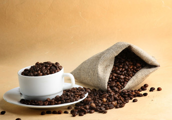 A sack of coffee beans and a cup