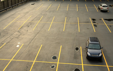 Aerial view of a parking lot with cars © shefkate