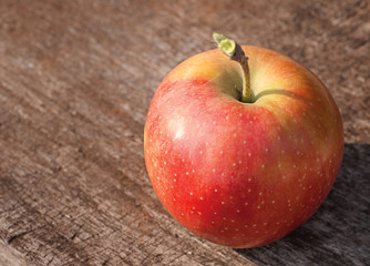 Red apple on old wooden table