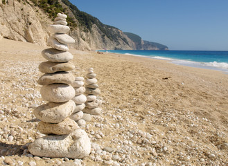 Stones balance, pebbles stack over blue sea