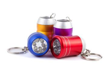 Set of four metal LED flashlight keychain isolated on white back