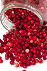 cranberries spilling from glass jar