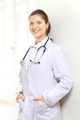 A portrait of a female doctor indoors on white