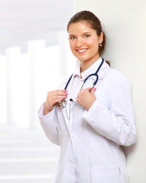 A portrait of a female doctor holding a stethoscope