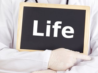 Doctor shows information on blackboard: life