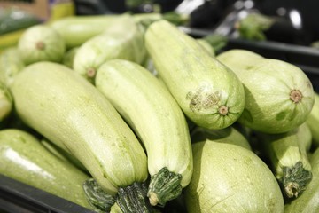 Green courgettes in a big grocery