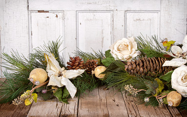 Christmas flowers and pine branches on wood