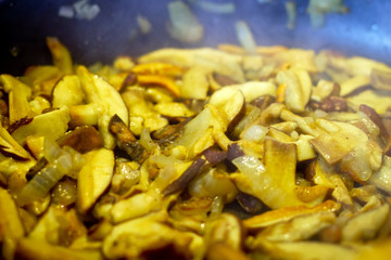 Mushrooms with onion frying on the pan