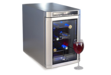 Wine refrigerator and glass of red wine.