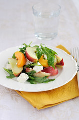 Summer fruit and goat cheese salad on a plate