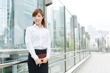 Beautiful business woman walking outside her office