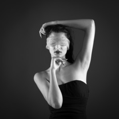 Close up of woman constrained by gauze ring on eyes. 