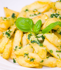 Potatoes fries in the plate with pesto sauce