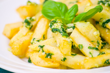 Potatoes fries in the plate with pesto sauce