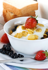 cereal, yogurt, strawberries and blueberries