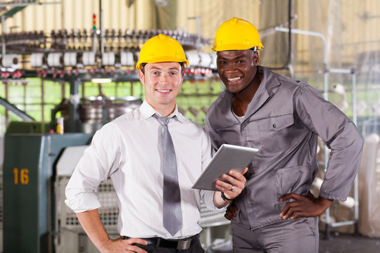 Modern Factory Manager And Worker With Tablet Computer