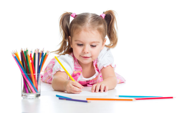 Cute girl drawing a picture with color pencils