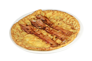 A board with a pancake with bacon strips on a white background.