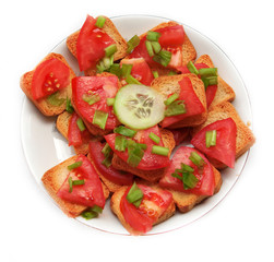 White plate with sandwiches with tomato and cucumber