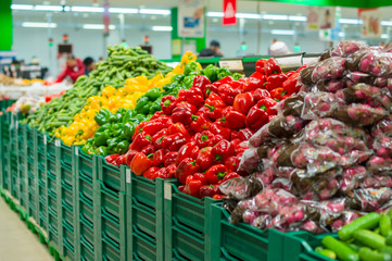 Bunch of red, green and yellow paprika pepper and raddish on box