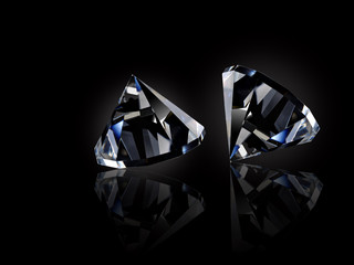 Two loose diamonds on black reflective surface © chones
