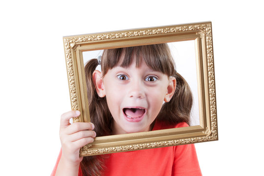 Little girl holding a frame for pictures