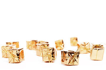 kleine goldene weihnachtsgeschenke auf weißem hintergrund