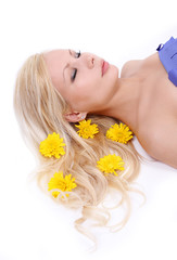 beautiful blonde young woman with yellow flowers in hair