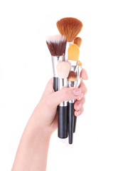 brushes for makeup in hand isolated on white