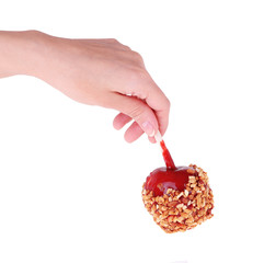 caramel candy apple in hand isolated on white