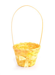 yellow wicker basket with bow isolated on white background