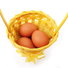 eggs in basket isolated on white background, closeup