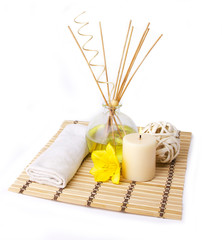 spa setting with aroma sticks and yellow flower isolated