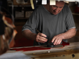 adult man working in a shoe factory