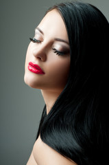 Fototapeta premium Brunette with perfect hair and red lipstick