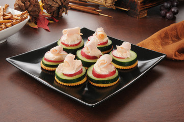 Canapes with cucumber, radish and cream cheese
