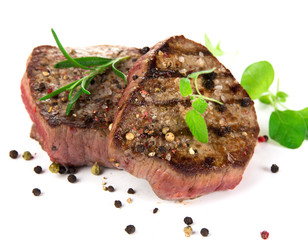 Grilled bbq steaks on white background