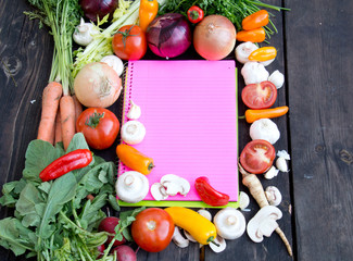 Pink paper for recipes on wood backround with vegetable