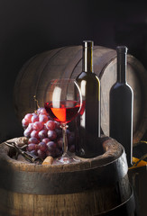 still life with red wine and old barrel
