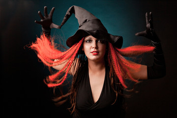 Witch practises witchcraft on black background.