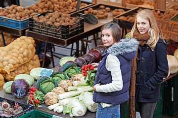 two young women at a market stand