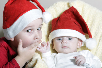 Beautiful child and newborn with Christmas hat