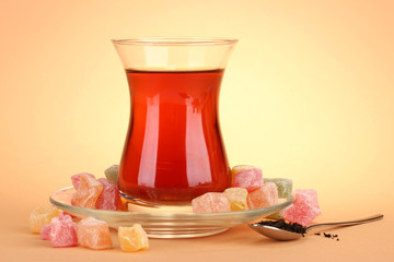 glass of Turkish tea and rahat Delight, on beige background