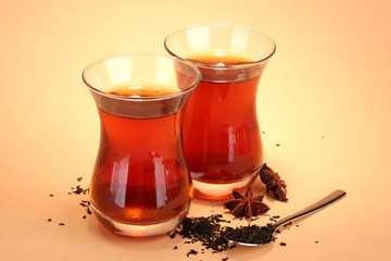 glasses of Turkish tea and rahat Delight, on beige background